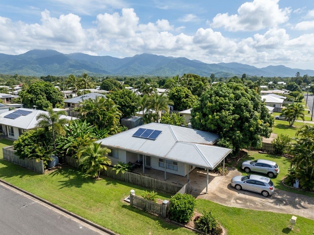 Aerial view of a Cairns suburb with the mountain range behind
